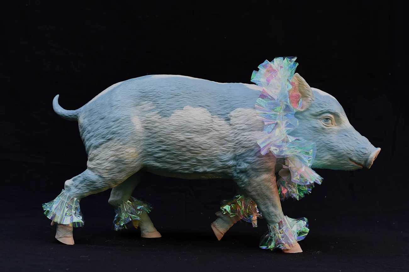 Hellblaues Schwein mit weißen Wolken bemalt, mit schillerndem Stoff als Hals-und Fußkrausen